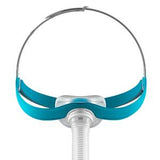 Nasal CPAP mask with blue headgear and flexible tube for sleep apnea therapy