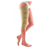 Beige compression wrap on leg for lymphedema or swelling relief, adjustable straps