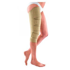 Beige compression wrap on leg for lymphedema or swelling relief, adjustable straps