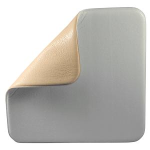 Square medical foam dressing with adhesive corner peeled back on white background