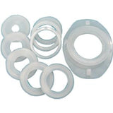 Set of circular white plastic medical adapters and rings on a plain background