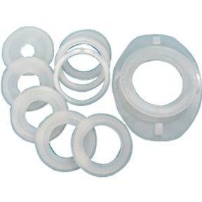 Set of circular white plastic medical adapters and rings on a plain background