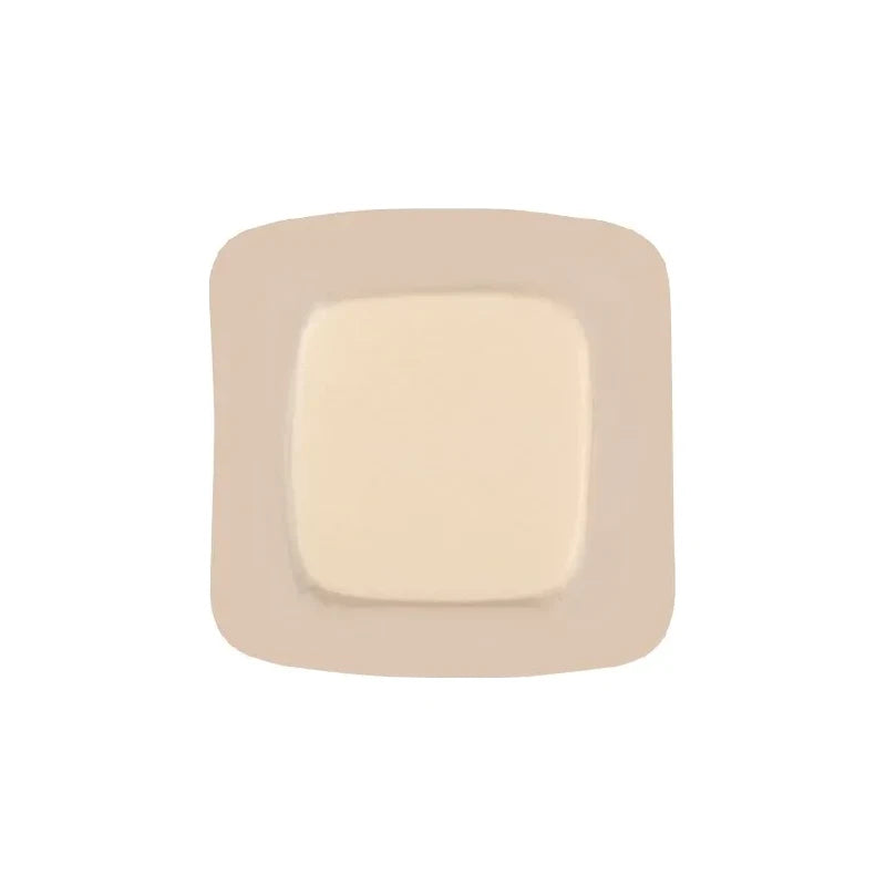 Sterile square medical adhesive wound dressing with beige border on white background