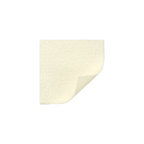 Square beige medical adhesive foam dressing with one corner slightly lifted