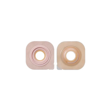 Two beige square ostomy barriers with round adhesive centers for stoma care