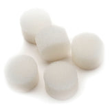 Five round white medical foam filters on a white surface, essential medical supplies