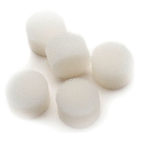 Five round white medical foam filters on a white surface, essential medical supplies