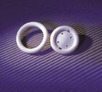 White medical silicone rings on purple textured background, incontinence device supplies