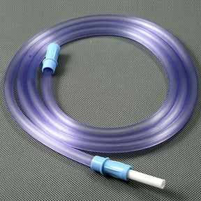 Transparent medical tubing with blue connectors on a gray perforated surface