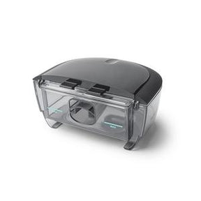 Transparent plastic CPAP humidifier water chamber on white background