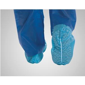 Blue disposable shoe covers on feet, protective medical supply for infection control