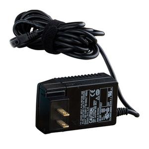 Black medical device power adapter with attached cord on white background