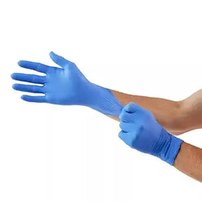 Person putting on blue disposable nitrile medical gloves, isolated on white background