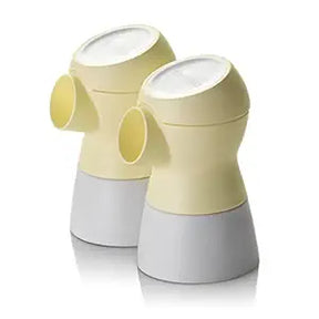 Pair of yellow and white breast pump replacement parts on white background