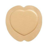 Heart-shaped beige hydrocolloid medical patch for wound care on white background