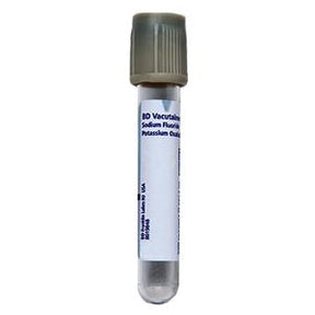 Empty medical blood collection tube with grey cap and labeled for laboratory use