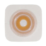 Ostomy barrier wafer with adhesive border for stoma care on white background