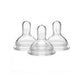 Three clear silicone baby bottle nipples for infant feeding, isolated on white background