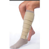 Leg with beige compression wrap and gray sock for medical support and edema relief
