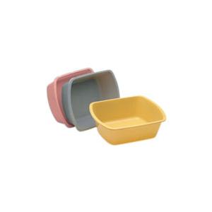 Stack of three plastic wash basins in yellow, gray, and pink for home medical use