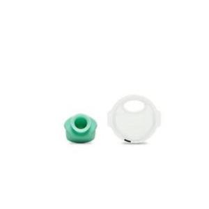 Small green medical device cap and white protective cover on white background