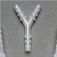 Y-shaped plastic tubing connector for medical supply, shown on a gray background