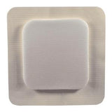 Square adhesive medical bandage with white absorbent pad on sterile background