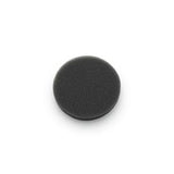 Black circular foam medical filter pad on white background, home medical accessory