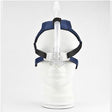 CPAP nasal mask with headgear and hose on white mannequin, medical sleep apnea aid