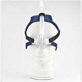 CPAP nasal mask with headgear and hose on white mannequin, medical sleep apnea aid