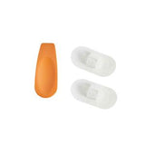 Orange applicator with two white adhesive medical patches on white background