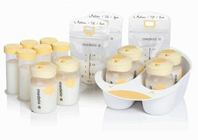 Breast milk storage bottles and bags with yellow lids, organized in a white tray
