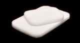 Sterile white medical gauze pads stacked on a black background