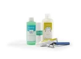 Medical hygiene supplies including bottles, tubes, and a disposable razor on white background