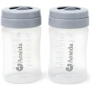 Two Ameda breast milk storage bottles with measurement markings and grey lids