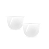 Two white disposable medicine cups for medical supply use on a white background.