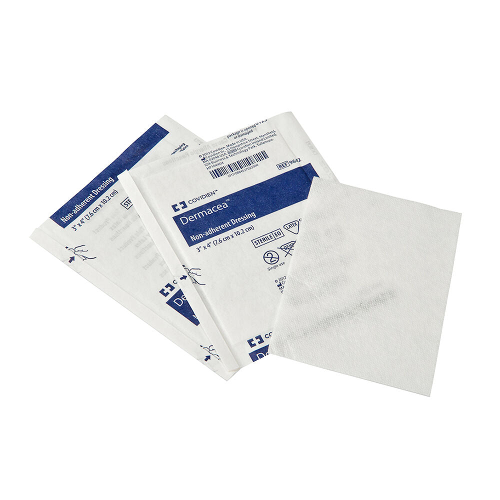 Sterile non-adherent medical dressing pads in individual packaging on white background