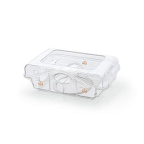 Clear plastic CPAP humidifier water chamber on white background, medical supply accessory.