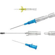 Various medical needles and IV catheters with colored hubs on a white background