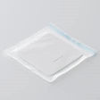 Sterile medical dressing pad in sealed transparent packaging on white background