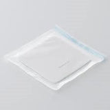 Sterile medical dressing pad in sealed transparent packaging on white background