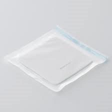 Sterile medical dressing pad in sealed transparent packaging on white background