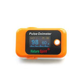 Orange pulse oximeter displaying SpO2 and pulse rate, labeled Nature Spirit.