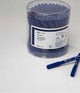 Container of blue insulin syringes with two pens on a white surface, medical supplies