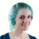 Smiling woman wearing disposable medical bouffant cap for hygiene