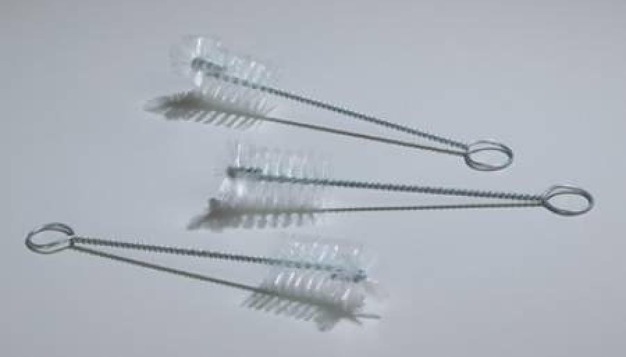 Three small wire cleaning brushes with clear bristles on a white background