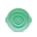 Green silicone collapsible bowl with ridged, circular design, viewed from above