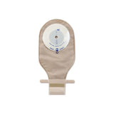 Beige drainable ostomy pouch with adhesive barrier on white background