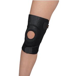 Adjustable black knee brace with open patella on a person's leg for joint support