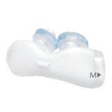 White medical device with two clear silicone nasal pillows, medium size, on white background
